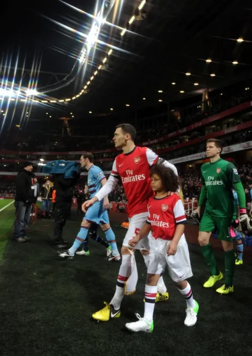 Framed Print : Thomas Vermaelen (Arsenal) walks out onto the pitch with the mascot. Arsenal 5: 1 West Ham United Framed Print : Thomas Vermaelen (Arsenal) walks out onto the pitch with the mascot. Arsenal 5: 1 West Ham United