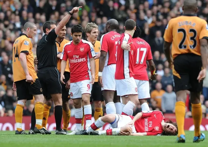 Framed Print : Tomas Rosicky (Arsenal) injured after a challenge from Wolves captain Carl Henry