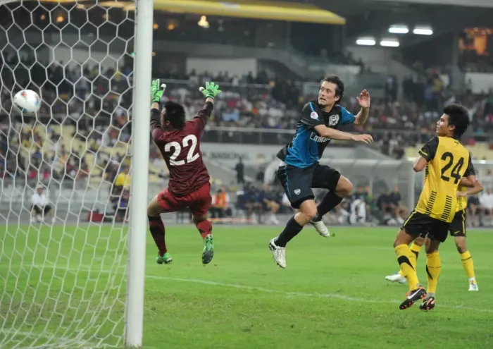 Framed Print : Tomas Rosicky heads past Malaysia goalkeeper Khairul Che Mat to score the 4th Arsenal goal Framed Print : Tomas Rosicky heads past Malaysia goalkeeper Khairul Che Mat to score the 4th Arsenal goal