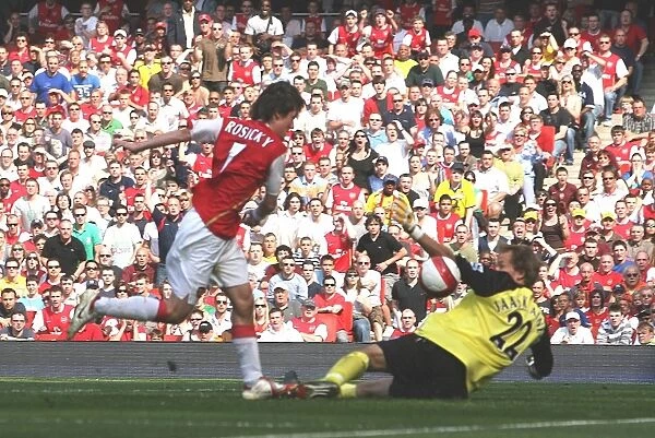 Tomas Rosicky shoots past Bolton goalkeeper Jussi Jaskelainen to score the first Arsenal goal