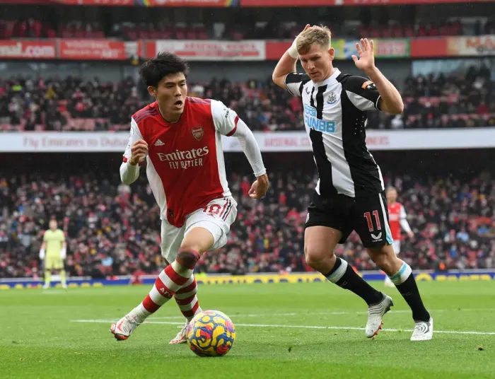 Framed Print : Tomiyasu vs Ritchie: A Battle of Wits in the Arsenal vs Newcastle Premier League Clash