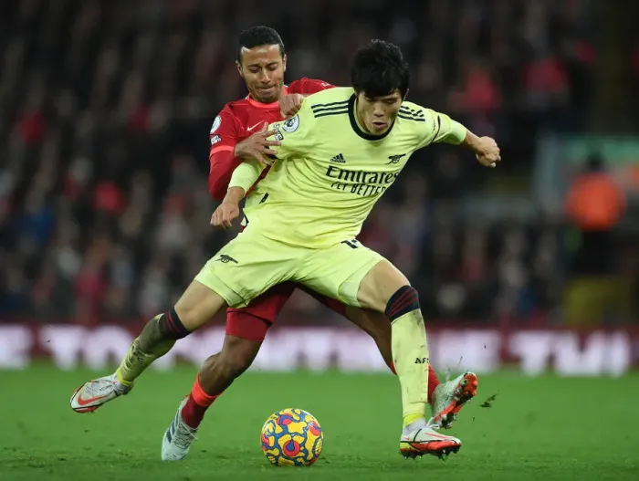Framed Print : Tomiyasu vs. Thiago: A Premier League Battle at Anfield Framed Print : Tomiyasu vs. Thiago: A Premier League Battle at Anfield