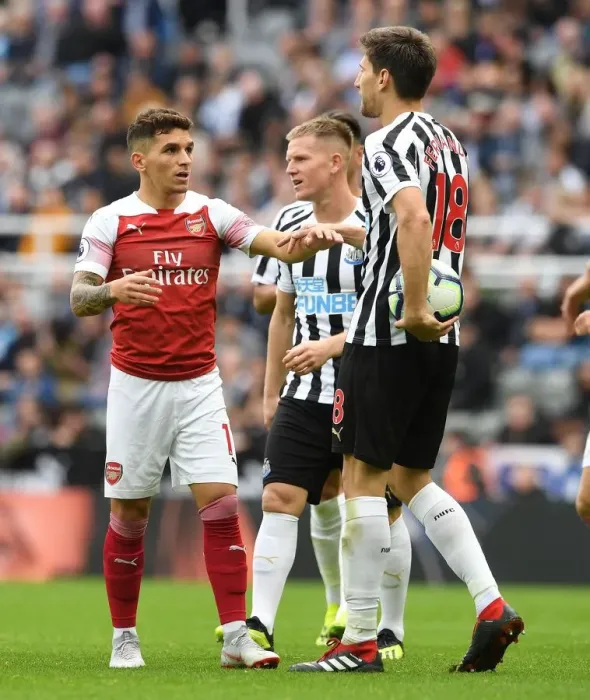 Framed Print : Torreira vs. Fernandez: Intense Battle in Newcastle United vs. Arsenal FC Premier League Clash Framed Print : Torreira vs. Fernandez: Intense Battle in Newcastle United vs. Arsenal FC Premier League Clash
