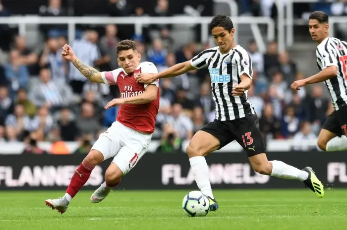 Framed Print : Torreira vs Muto: A Fierce Battle in Newcastle United vs Arsenal FC Premier League Clash - The Duel at St. James Park