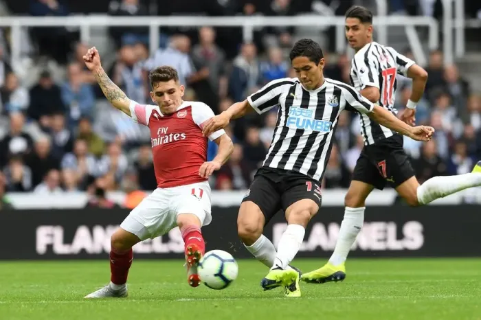 Framed Print : Torreira vs Muto: Intense Battle in Newcastle United vs Arsenal FC Premier League Clash