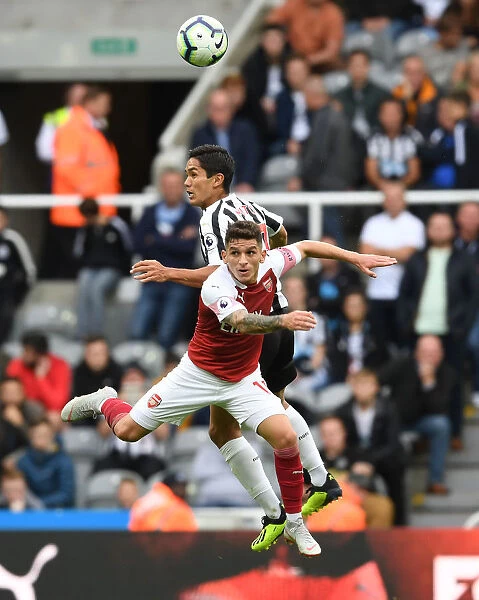 Torreira vs. Muto: A Premier League Battle at St. James Park - Arsenal's Torreira Clashes with Newcastle's Muto