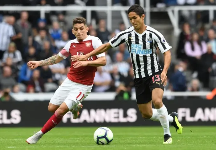 Framed Print : Torreira vs. Muto: A Premier League Battle at St. James Park - Arsenal's Torreira Clashes with Newcastle's Muto