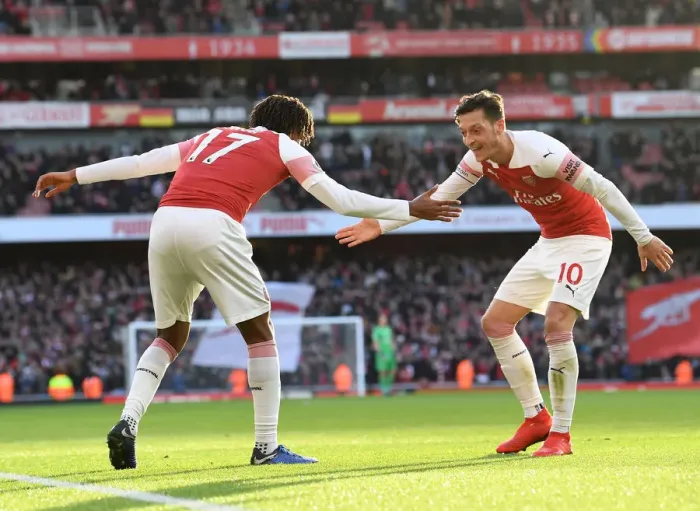 Framed Print : Triumphant Moment: Iwobi and Ozil's Euphoric Celebration after Iwobi's Goal for Arsenal against Burnley (2018-19)