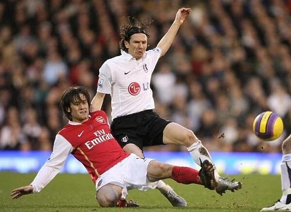 Triumphant Rivals: Rosicky's Double Strike Against Smertin and Fulham