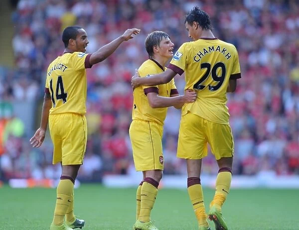 Triumphant Threesome: Chamakh, Arshavin, Walcott Celebrate Arsenal's Goal at Anfield