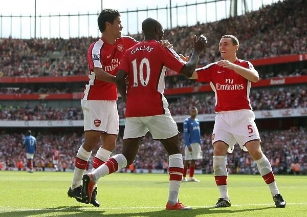 Triumphant Threesome: William Gallas, Eduardo, and Thomas Vermaelen Celebrate Arsenal's 4-1 Victory Over Portsmouth