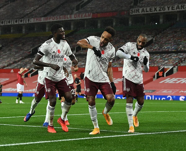 Triumphant Trio: Aubameyang, Partey, and Lacazette Celebrate Goal at Empty Old Trafford (Manchester United vs Arsenal, 2020-21)