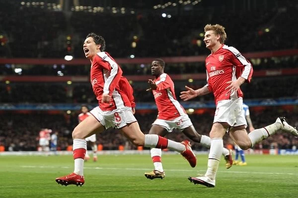 Triumphant Triple: Nasri, Bendtner, and Eboue Celebrate Arsenal's 5-0 Victory over FC Porto