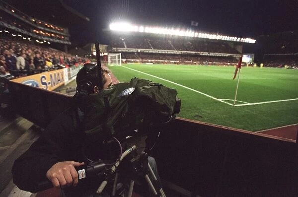 A TV Cameraman works under the floodlights which are on for the last time