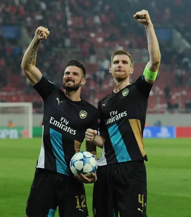 Framed Print : Unforgettable Celebration: Giroud and Mertesacker's Victory Moment at Olympiacos vs. Arsenal, UEFA Champions League (December 2015) Framed Print : Unforgettable Celebration: Giroud and Mertesacker's Victory Moment at Olympiacos vs. Arsenal, UEFA Champions League (December 2015)