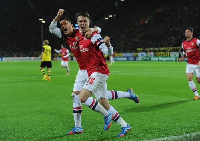 Framed Print : Unforgettable: Ramsey and Ozil's Euphoric Goal Celebration at Borussia Dortmund, Arsenal in the UEFA Champions League (2013-14)