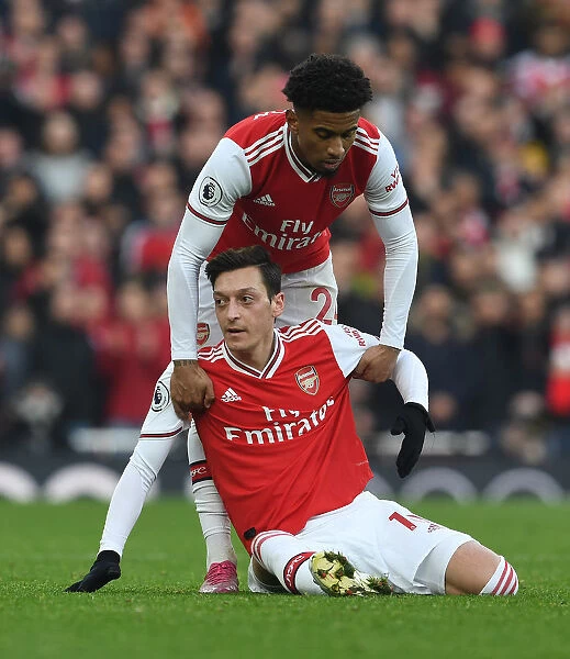 United in Support: Ozil and Nelson's Heartwarming Moment of Camaraderie Amidst Arsenal-Chelsea Rivalry
