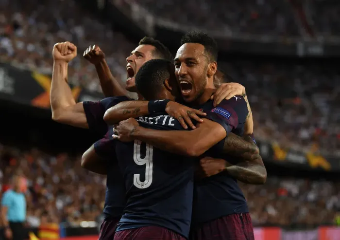Framed Print : United in Victory: Aubameyang, Lacazette, and Xhaka's Triumphant Goal Celebration in Arsenal's Europa League Semi-Final Win over Valencia