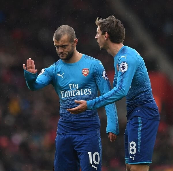 Unwavering Focus: Monreal and Wilshere's Intense Concentration during Arsenal's Premier League Clash at Southampton (2017-18)
