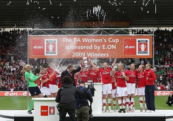 Vic Akers and his Arsenal Ladies lift the FA Cup Trophy