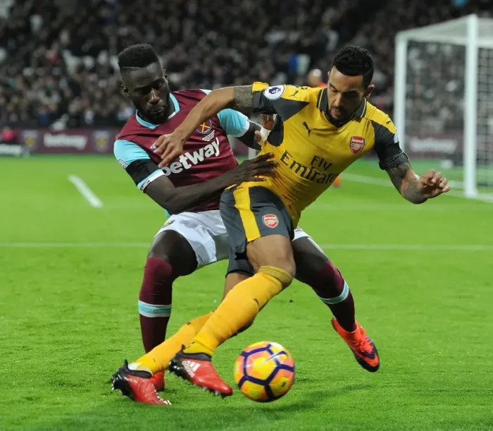 Framed Print : Walcott vs. Masuaku: A Football Rivalry Erupts in the West Ham United vs. Arsenal Clash