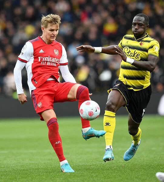 Watford vs Arsenal: Martin Odegaard Faces Pressure from Moussa Sissoko in Premier League Clash