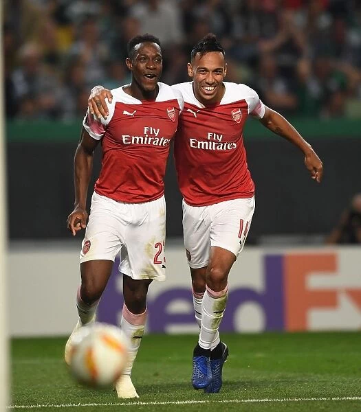 Welbeck and Aubameyang Celebrate Goal: Arsenal's Victory Moment against Sporting Lisbon in Europa League