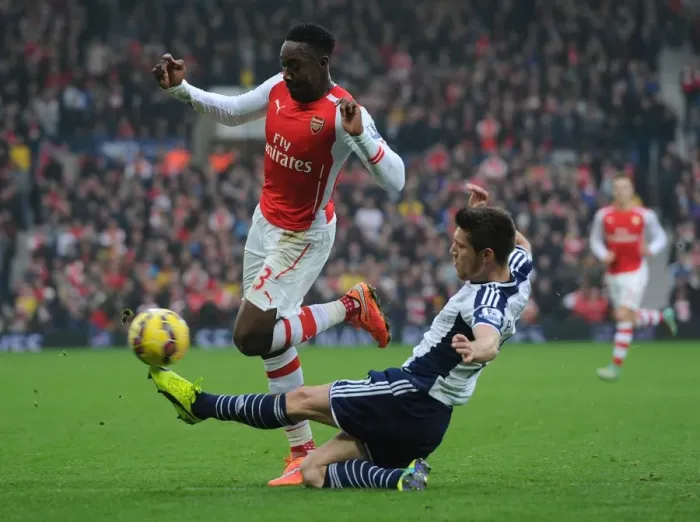 Framed Print : Welbeck vs Pocognoli: Intense Tackle in Arsenal's Premier League Clash with West Bromwich Albion