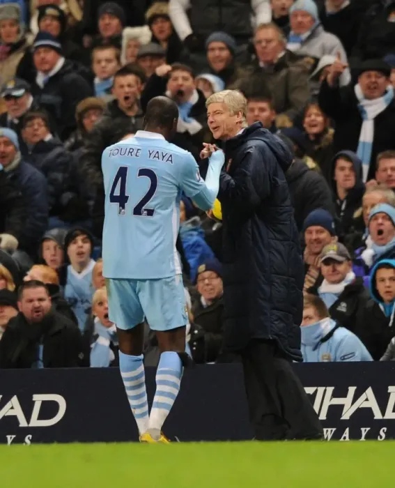Framed Print : Wenger and Toure: A Light-Hearted Moment Amidst the Manchester Rivalry (2011-12)