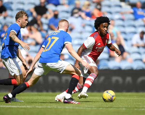 Willian Clashes with Rangers Scott Arfield and Stephen Kelly in Arsenal's Pre-Season Friendly at Ibrox Stadium