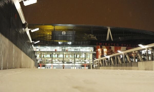 Winter's Embrace at Arsenal's Fortress: A Snowy Emirates Stadium