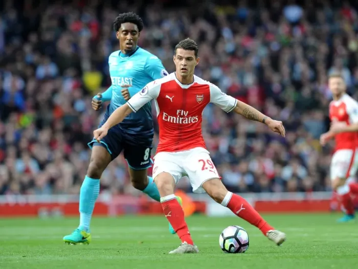 Framed Print : Xhaka Under Pressure: Arsenal's Midfielder Faces Intense Scrutiny from Swansea's Fer in Premier League Showdown Framed Print : Xhaka Under Pressure: Arsenal's Midfielder Faces Intense Scrutiny from Swansea's Fer in Premier League Showdown