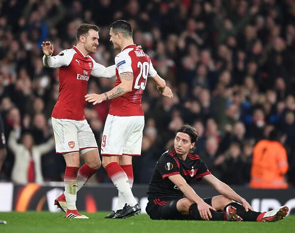 Xhaka and Ramsey Celebrate Arsenal's Goals Against AC Milan in Europa League Clash