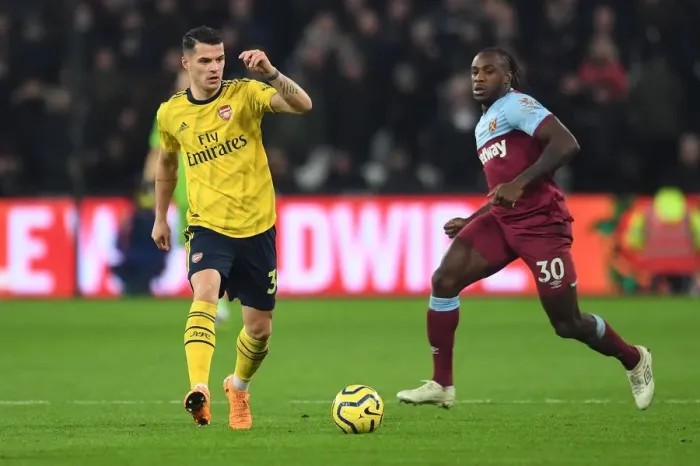 Framed Print : Xhaka vs Antonio: Intense Battle in West Ham United vs Arsenal FC Premier League Clash
