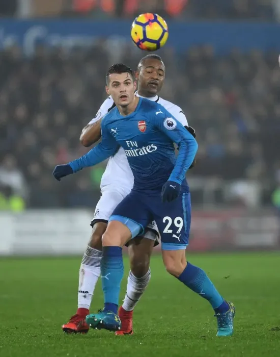 Framed Print : Xhaka vs Ayew: Intense Battle in Swansea City vs Arsenal Premier League Clash
