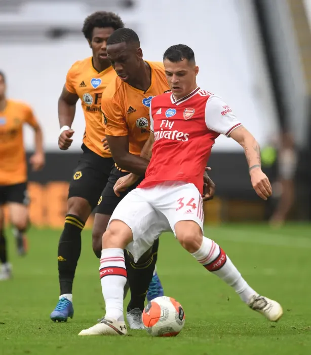 Framed Print : Xhaka vs Bolly: Intense Battle in Wolverhampton Wanderers vs Arsenal FC Premier League Clash