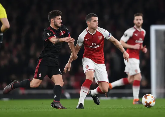 Framed Print : Xhaka vs. Cutrone: Battle in the Europa League as Arsenal Face Off Against AC Milan