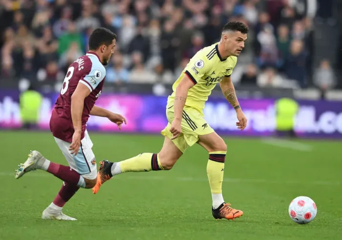 Framed Print : Xhaka vs Fornals: Intense Battle in West Ham United vs Arsenal Premier League Clash