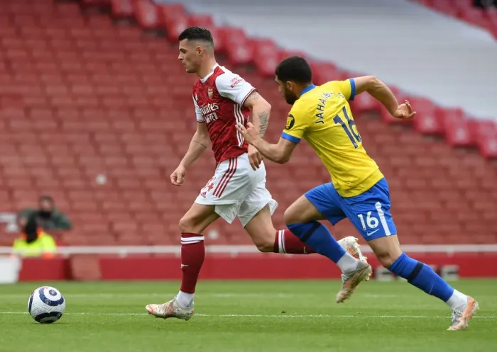 Framed Print : Xhaka vs. Jahanbakhsh: Intense Clash in Arsenal vs. Brighton Premier League Battle (2020-21)