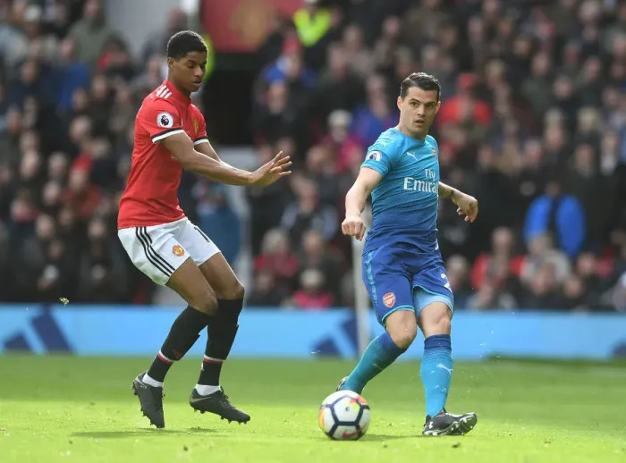 Framed Print : Xhaka vs Rashford: Intense Battle in Manchester United vs Arsenal Premier League Clash Framed Print : Xhaka vs Rashford: Intense Battle in Manchester United vs Arsenal Premier League Clash