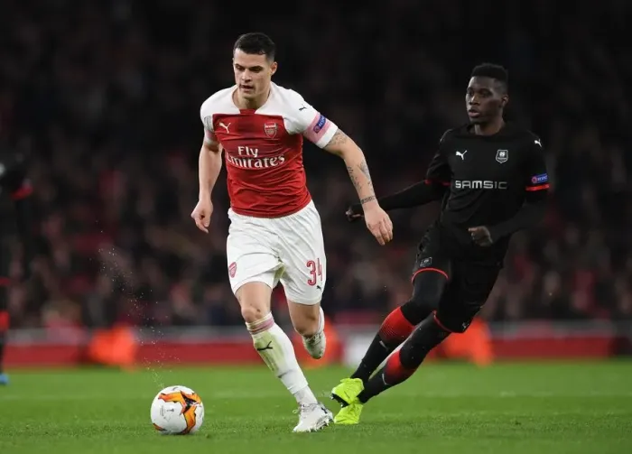 Framed Print : Xhaka vs Sarr: A Europa League Battle – Arsenal's Granit Xhaka and Stade Rennais Ismaila Sarr Clash in Dramatic Showdown Framed Print : Xhaka vs Sarr: A Europa League Battle – Arsenal's Granit Xhaka and Stade Rennais Ismaila Sarr Clash in Dramatic Showdown