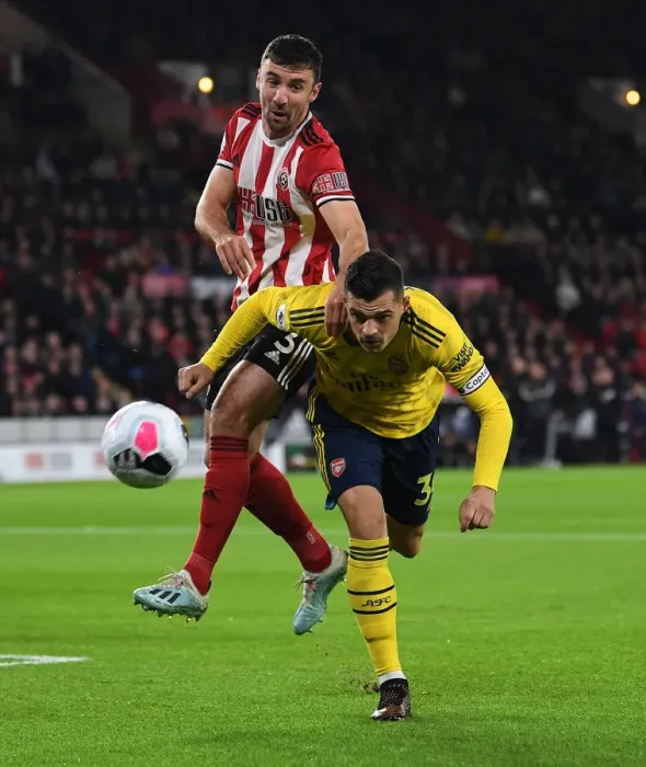 Framed Print : Xhaka vs Stevens: Intense Battle in Sheffield United vs Arsenal Premier League Clash