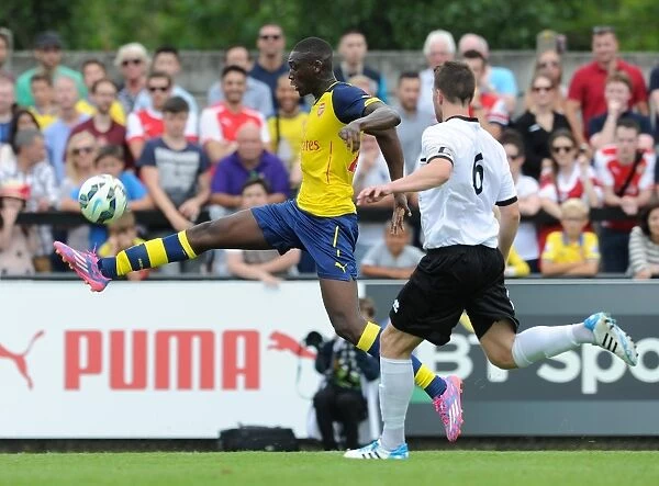 Yaya Sanogo (Arsenal) Callum Reynolds (Boreham Wood). Boreham Wood 0: 2 Arsenal. Pre Season Friendly
