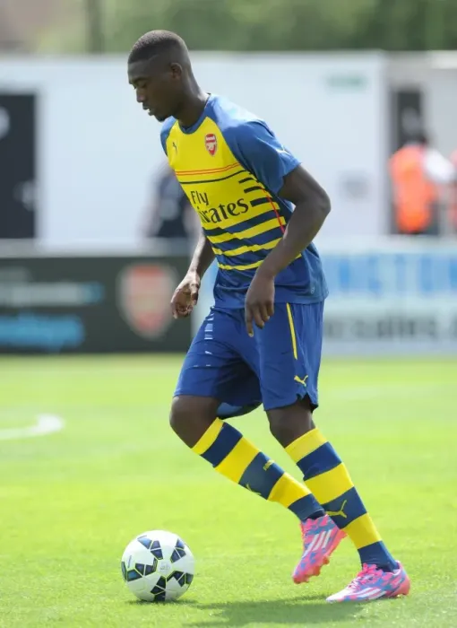 Framed Print : Yaya Sanogo (Arsenal) warms up before the match. Boreham Wood 0: 2 Arsenal. Pre Season Friendly