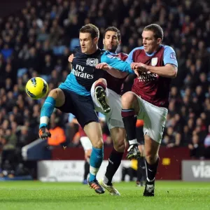 Aaron Ramsey Faces Off Against Carlos Cuellar and Richard Dunne in Intense Aston Villa vs. Arsenal Clash