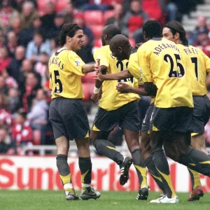 Abou Diaby is congratulated by Cesc Fabregas and Emmanuel Adebayor for pressuring Danny Collins