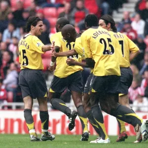 Abou Diaby is congratulated by Cesc Fabregas and Emmanuel Adebayor for pressuring Danny Collins
