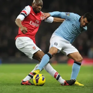 Abou Diaby vs. Carlos Tevez: Intense Tackle in Arsenal vs. Manchester City Premier League Clash (2012-13) Abou Diaby vs. Carlos Tevez: Intense Tackle in Arsenal vs. Manchester City Premier League Clash (2012-13)