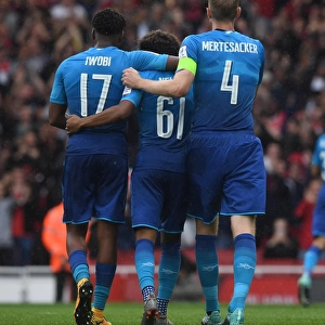 Alex Iwobi and Per Mertesacker congratulate Reiss Nelson on his assist. Arsenal 5