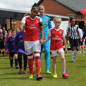 Alex Scott (Arsenal Ladies) and the mascot before the match